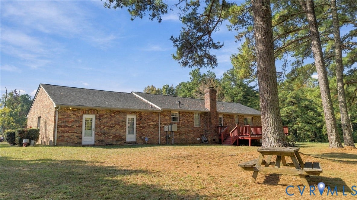 Back yard with large deck.  Area has had lots of large cookouts here!