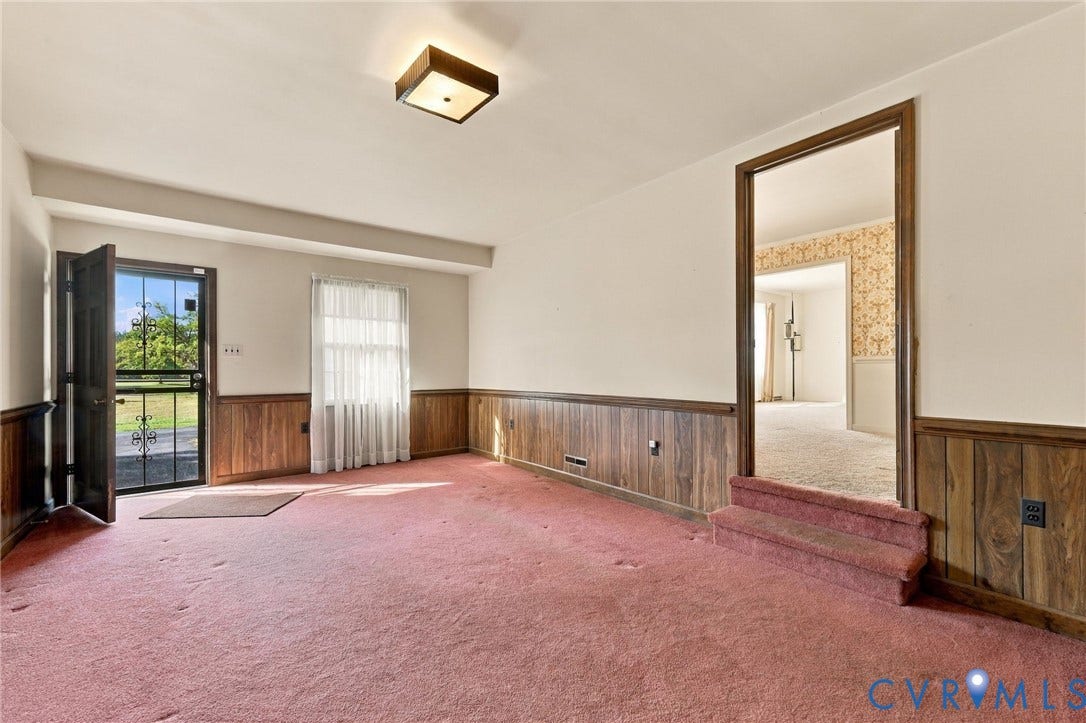 Rec Room with exterior door next to garage.