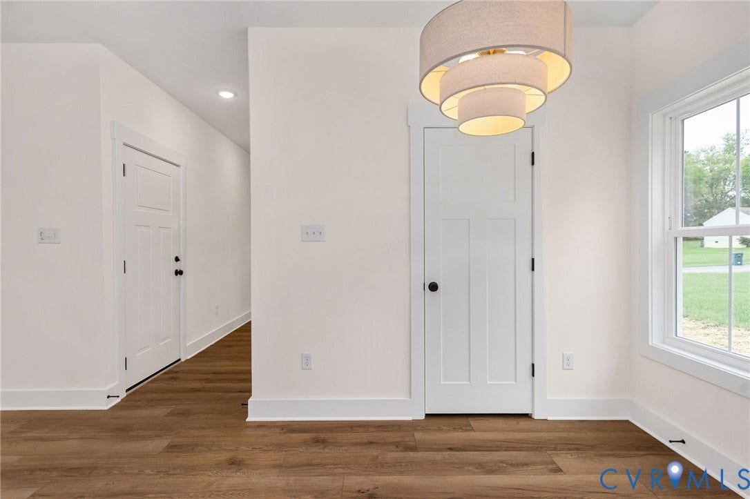 7605 Oster Drive, Chamberlayne Farms Area, Henrico, VA 23227 Wood-finish flooring, white trim, contemporary layered drum light fixture, recessed lighting, and white paneled doors