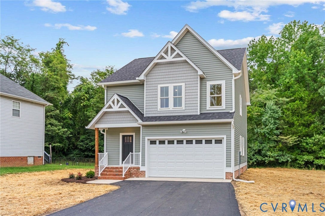 7605 Oster Drive, Chamberlayne Farms Area, Henrico, VA 23227 Two-story residence featuring light gray siding with shake accents, a dark shingle roof, an attached white garage door, and a covered porch with white railings
