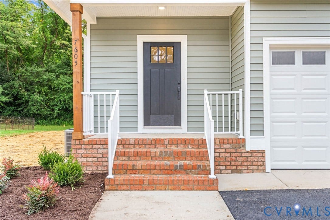7605 Oster Drive, Chamberlayne Farms Area, Henrico, VA 23227 Entryway featuring brick steps, white railings, and a dark paneled door with windowpanes