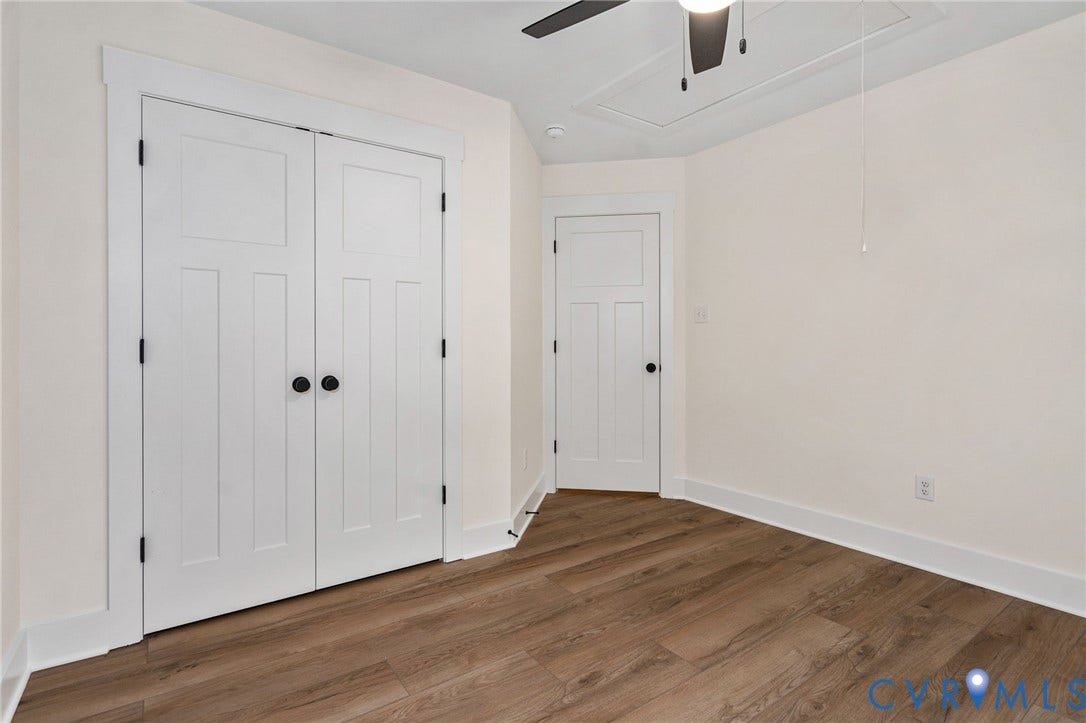 7605 Oster Drive, Chamberlayne Farms Area, Henrico, VA 23227 Wood-finish flooring, white paneled doors with black hardware, and a ceiling fan with light fixture