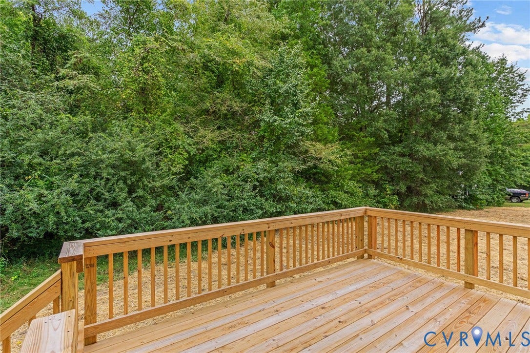 7605 Oster Drive, Chamberlayne Farms Area, Henrico, VA 23227 Expansive wood deck with natural wood railing, surrounded by mature trees and lush natural landscaping