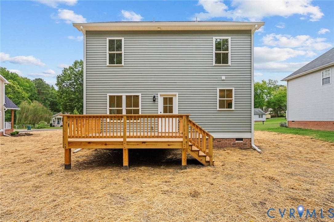 7605 Oster Drive, Chamberlayne Farms Area, Henrico, VA 23227 Spacious two-story home with vinyl siding and multi-pane windows, featuring a substantial wood-frame deck with railings and stairs