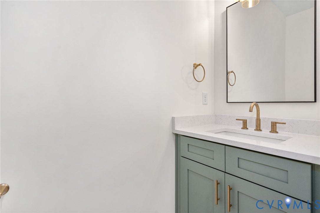 7605 Oster Drive, Chamberlayne Farms Area, Henrico, VA 23227 Vanity with integrated sink, light-toned countertop, and gold-finish fixtures