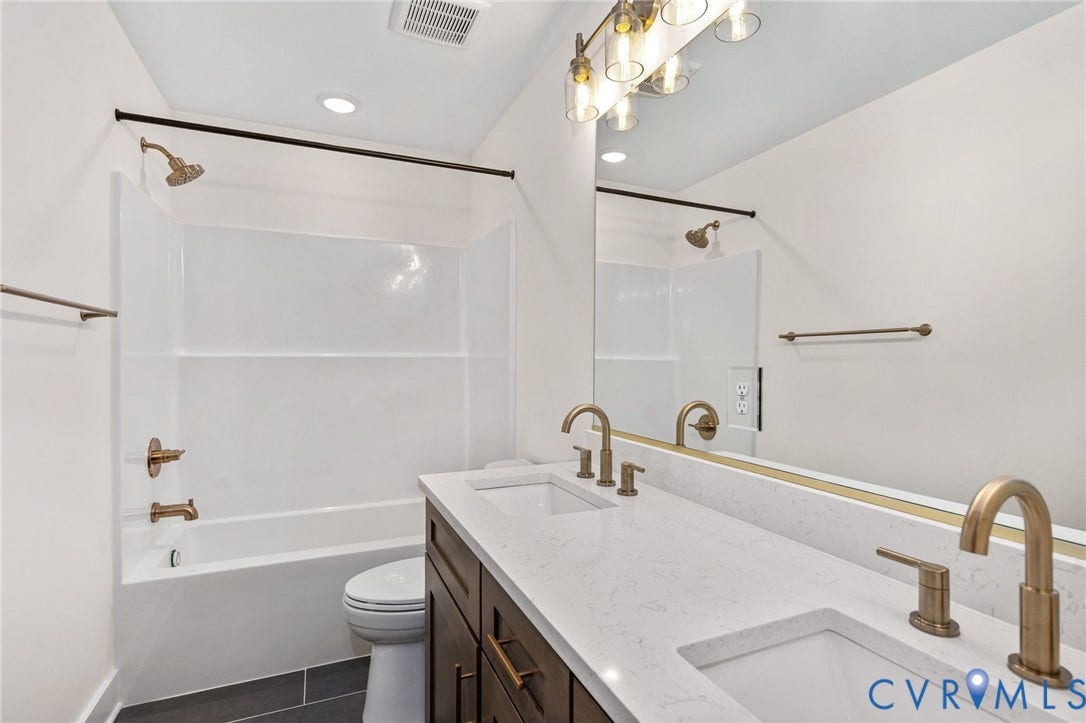 7605 Oster Drive, Chamberlayne Farms Area, Henrico, VA 23227 Dual vanity with a white countertop and bronze-finish fixtures