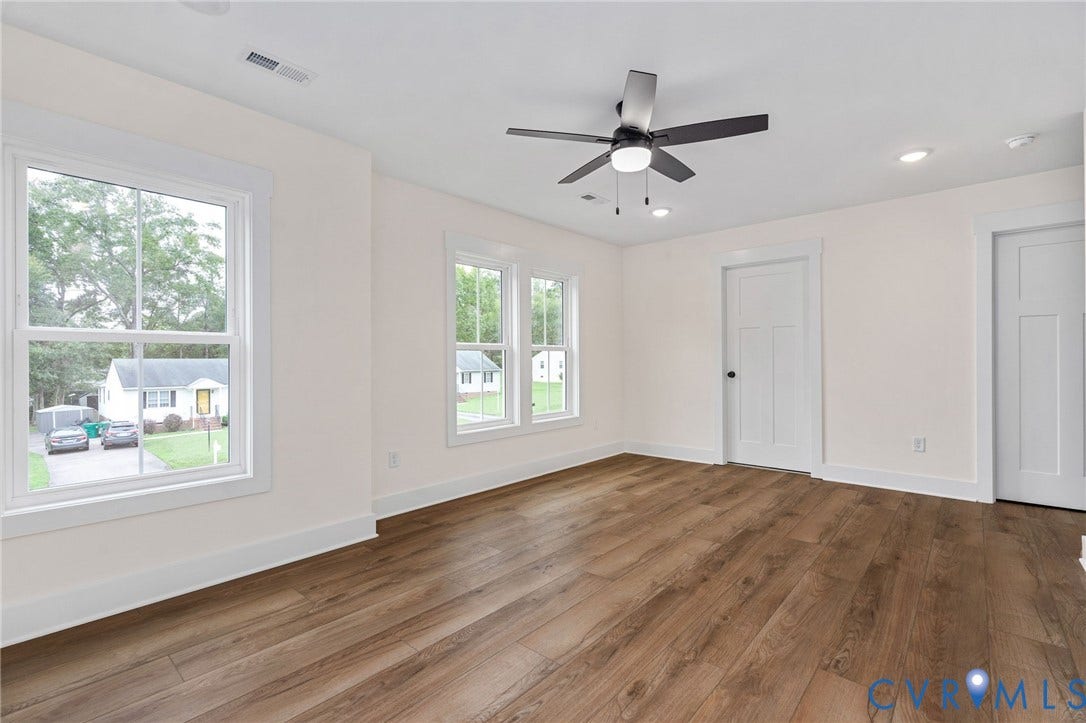 7605 Oster Drive, Chamberlayne Farms Area, Henrico, VA 23227 Expansive room featuring wood-finish flooring, multiple windows, a ceiling fan with integrated lighting, recessed lighting, and panel doors