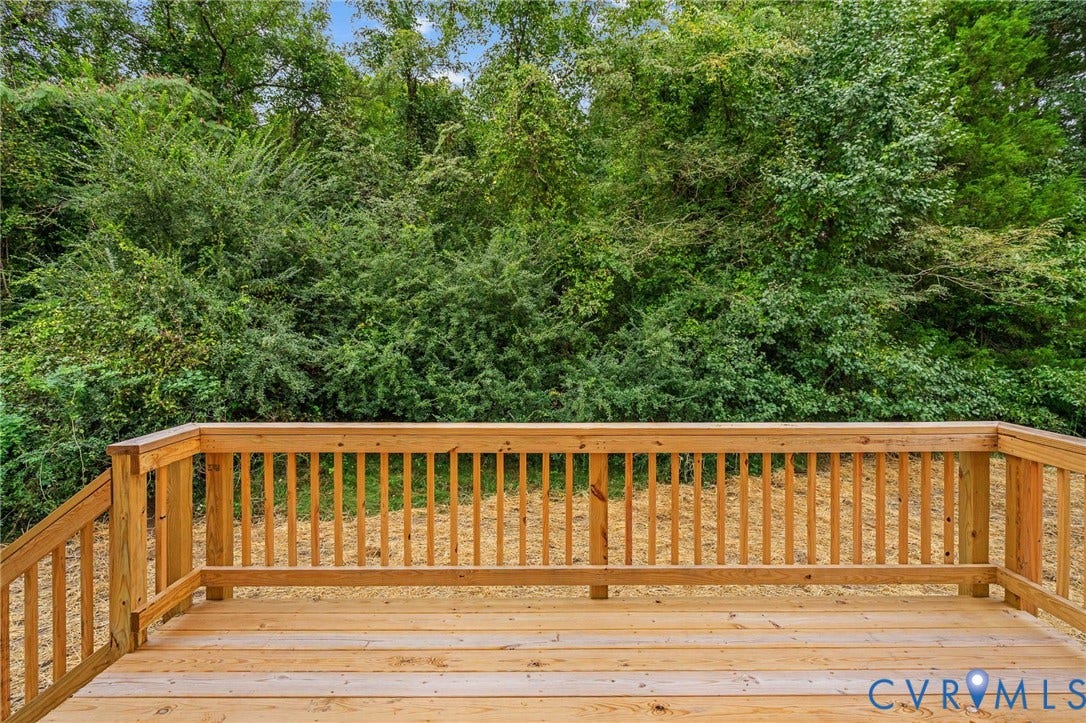 7605 Oster Drive, Chamberlayne Farms Area, Henrico, VA 23227 Expansive wooden deck with a built-in railing system, featuring natural wood tones and a surrounding natural landscape