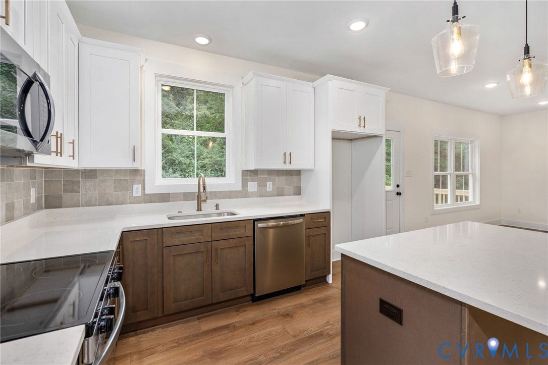 7605 Oster Drive, Chamberlayne Farms Area, Henrico, VA 23227 Modern kitchen with white upper and wood-finish lower cabinetry, light-toned countertops, and wood-finish flooring