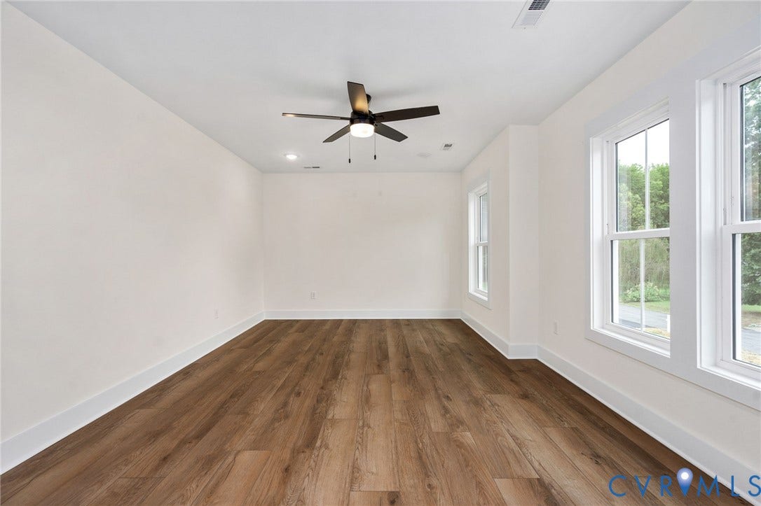 7605 Oster Drive, Chamberlayne Farms Area, Henrico, VA 23227 Wood-finish flooring, white walls, two double-hung windows, recessed lighting, and a ceiling fan with light fixture