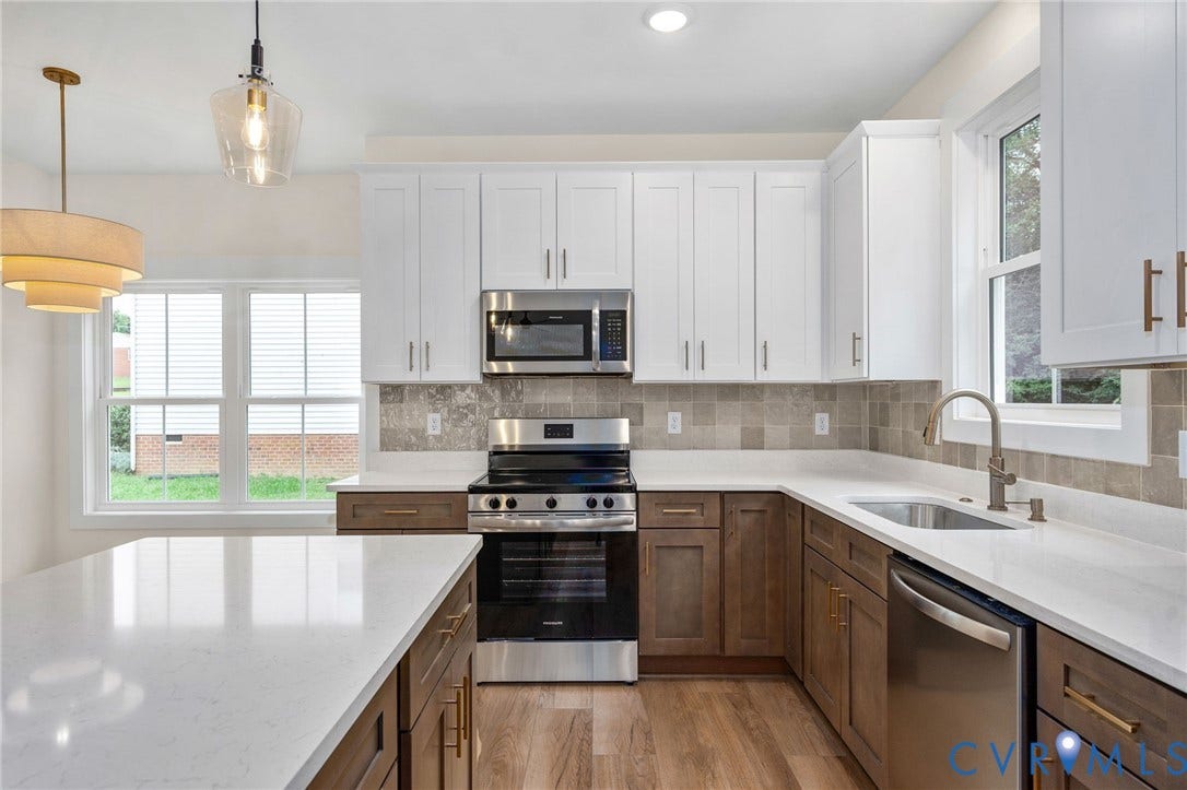 7605 Oster Drive, Chamberlayne Farms Area, Henrico, VA 23227 Kitchen with white shaker upper cabinetry, wood-finish lower cabinetry, light-toned countertops, tile backsplash, and stainless steel appliances