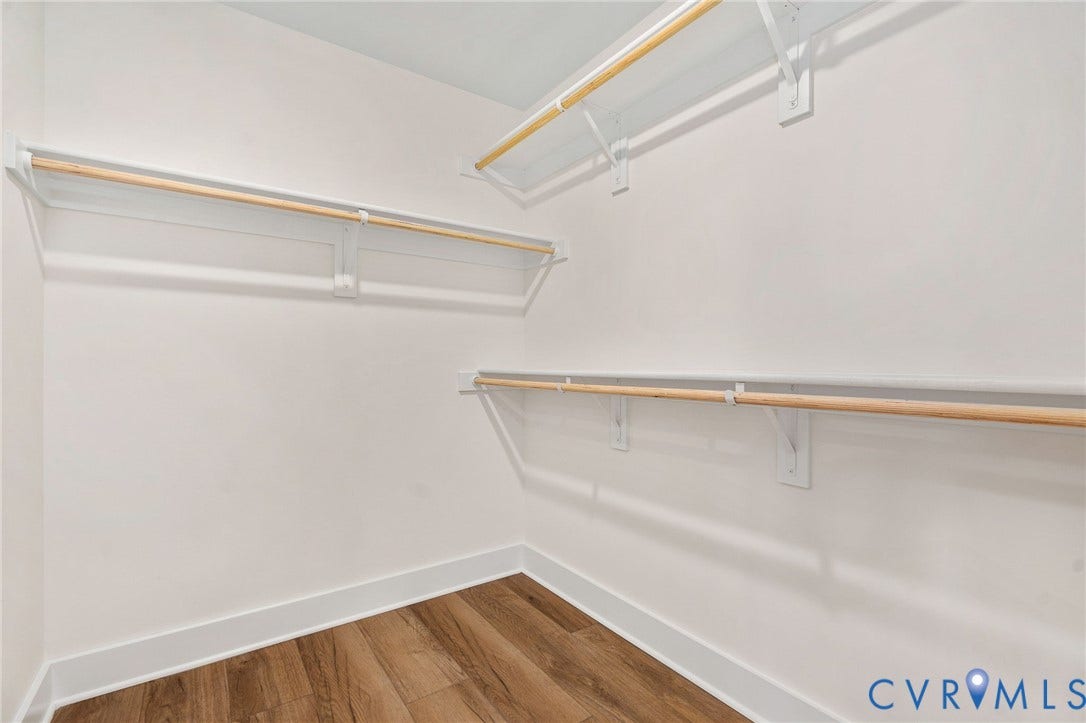 7605 Oster Drive, Chamberlayne Farms Area, Henrico, VA 23227 Spacious closet with multiple hanging rods, integrated shelving, and wood-finish flooring