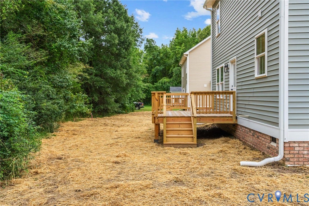 7605 Oster Drive, Chamberlayne Farms Area, Henrico, VA 23227 Rear exterior featuring horizontal siding, a wood deck with stairs, and a brick foundation
