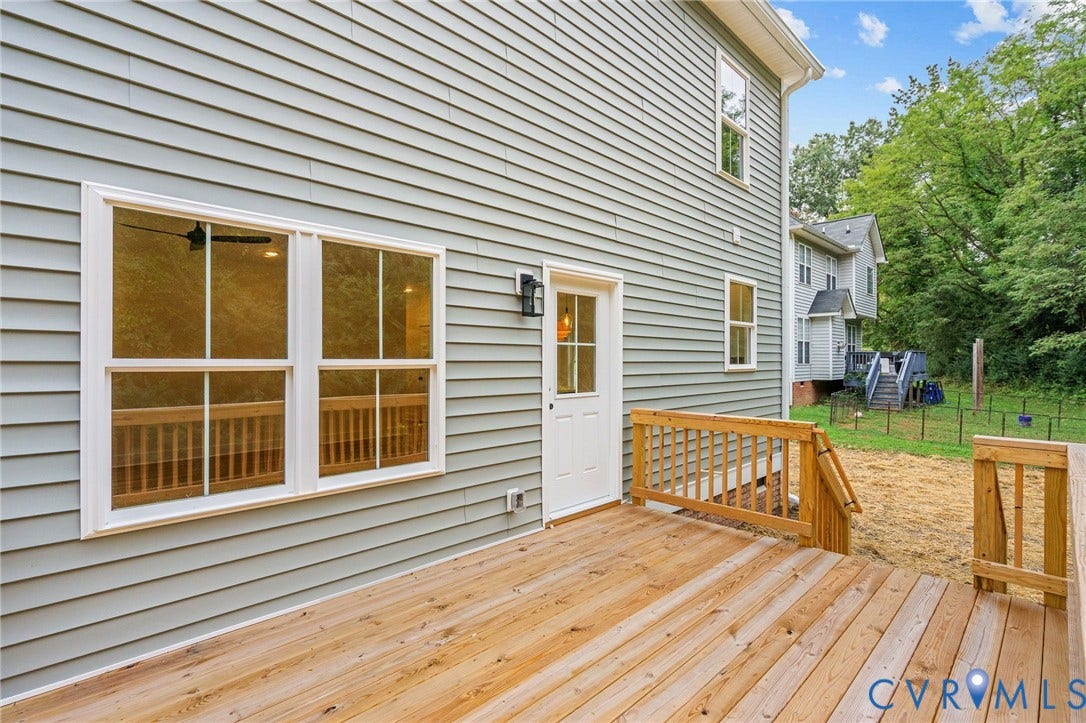 7605 Oster Drive, Chamberlayne Farms Area, Henrico, VA 23227 Expansive wooden deck with railing, siding exterior, multiple windows, and exterior lighting fixture