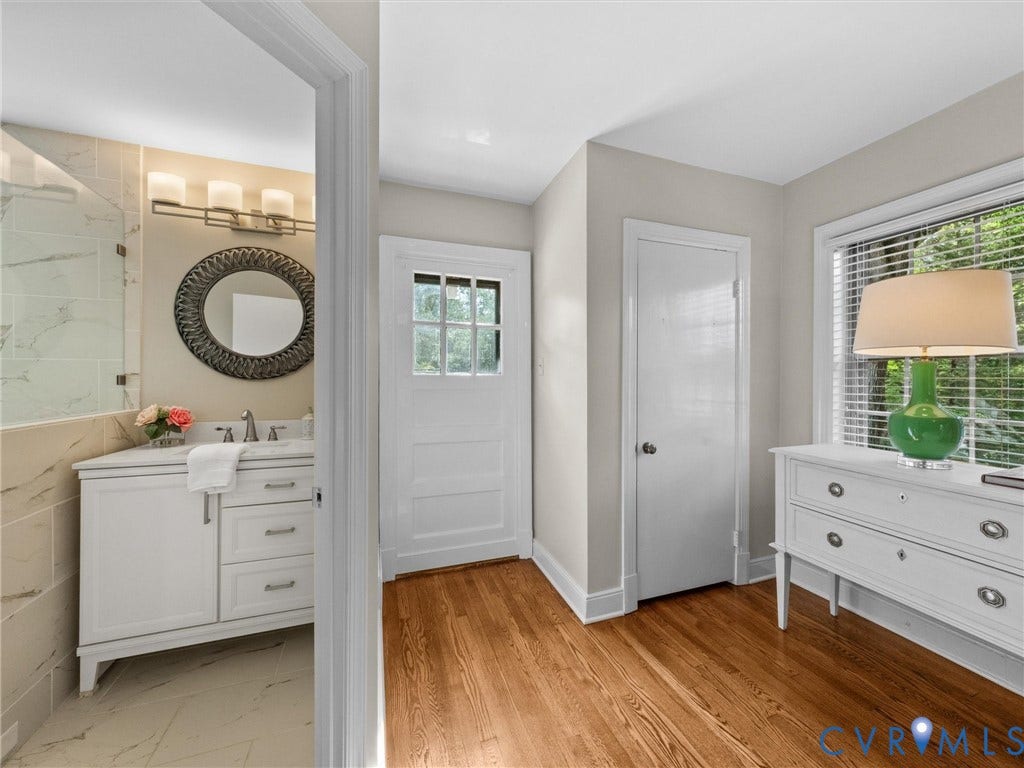 1113 E Durwood Crescent, Tuckahoe Area, Henrico, VA 23229 Hardwood flooring, recessed window, white paneled door, bathroom vanity with undermount sink, and tiled shower surround