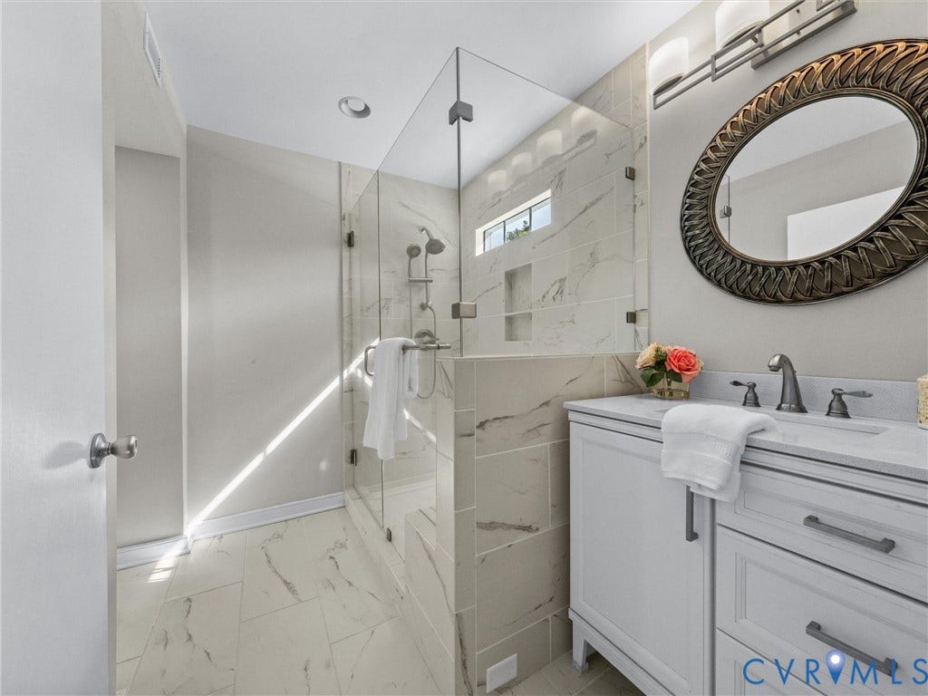 1113 E Durwood Crescent, Tuckahoe Area, Henrico, VA 23229 Glass-enclosed shower with tile surround and integrated niche, white vanity with stone countertop, and an ornate framed mirror