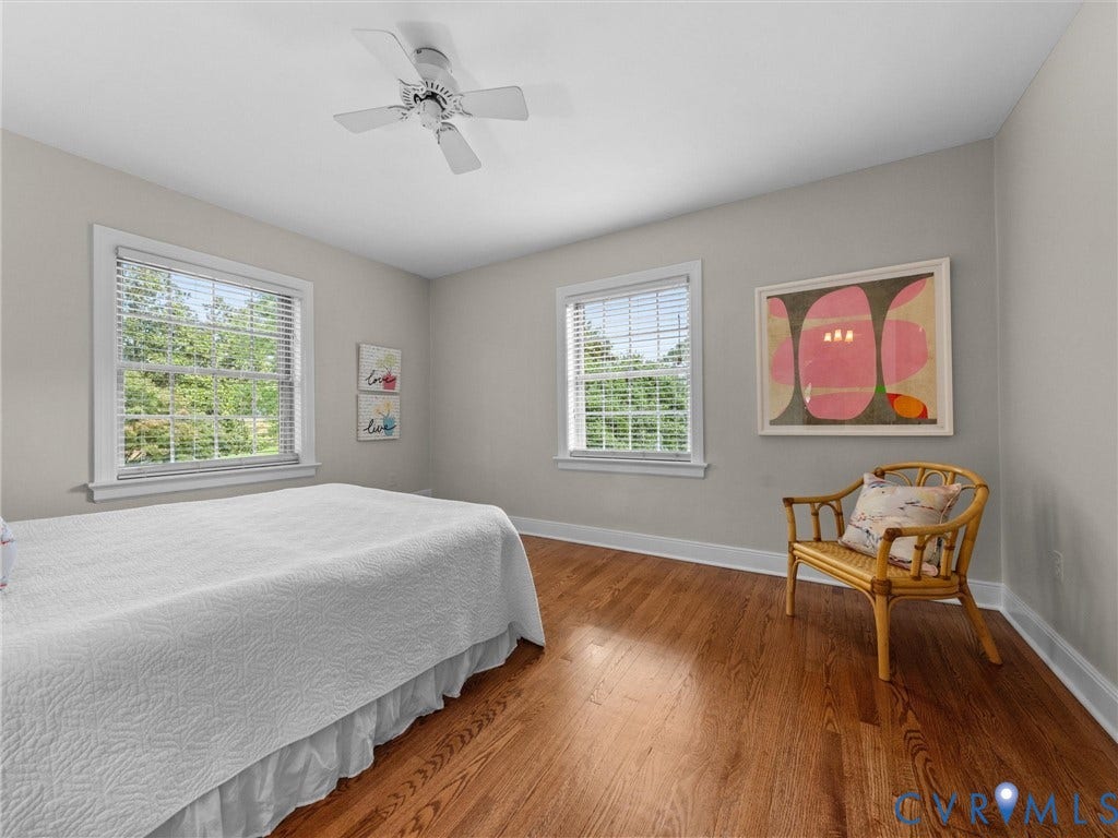 1113 E Durwood Crescent, Tuckahoe Area, Henrico, VA 23229 Hardwood flooring throughout, featuring two windows with blinds, a ceiling fan, and light gray wall paint