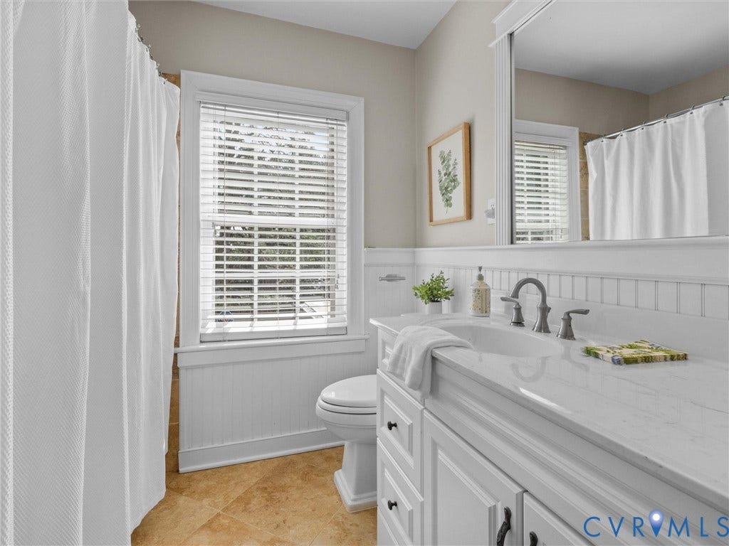 1113 E Durwood Crescent, Tuckahoe Area, Henrico, VA 23229 White vanity with an integrated sink, brushed nickel faucet, and a large mirror