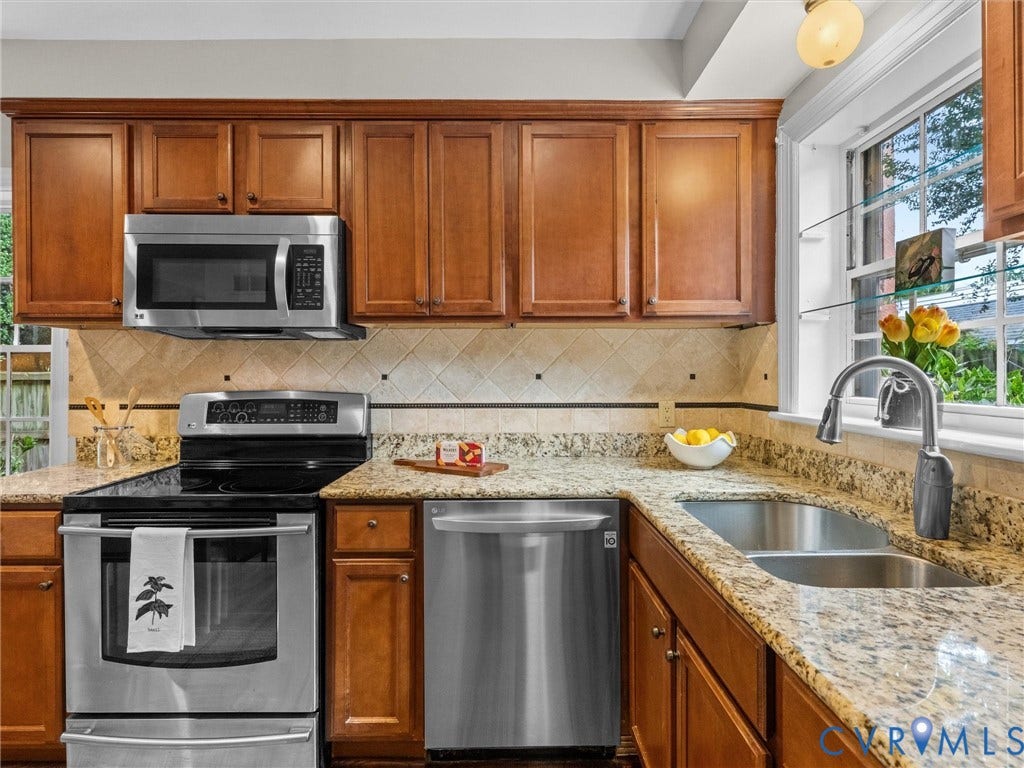 1113 E Durwood Crescent, Tuckahoe Area, Henrico, VA 23229 Kitchen featuring wood cabinetry, stainless steel appliances, speckled stone countertops, and a tile backsplash