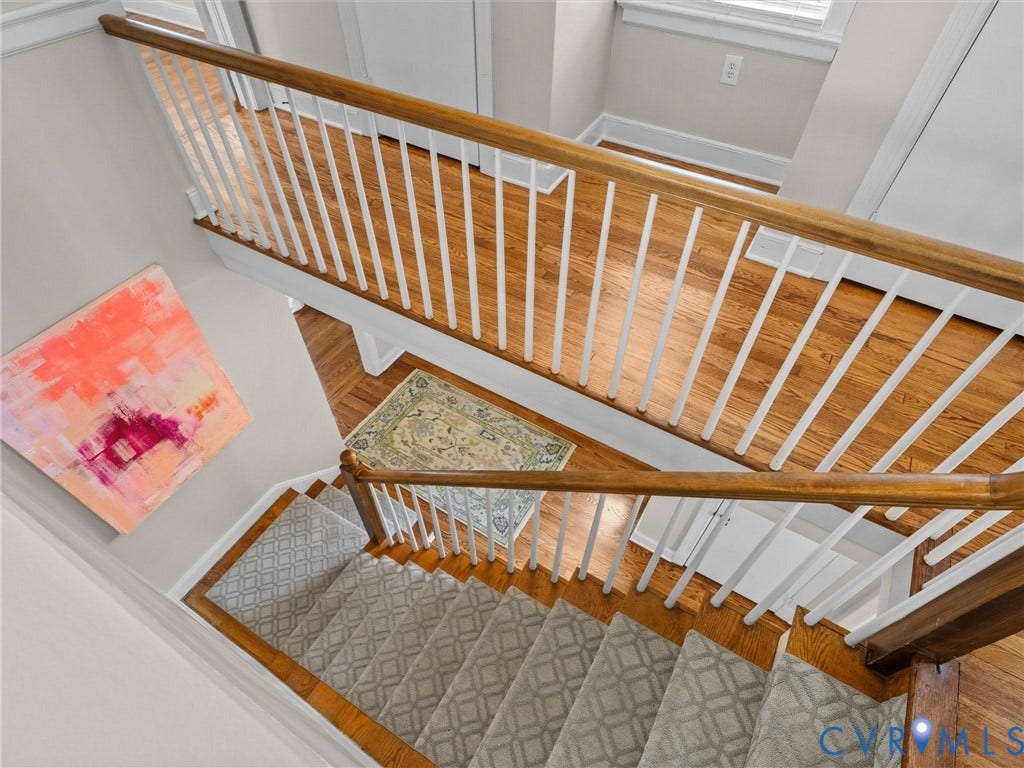 1113 E Durwood Crescent, Tuckahoe Area, Henrico, VA 23229 Hardwood flooring, painted white balusters, natural wood handrails, and carpeted stairs with a geometric pattern