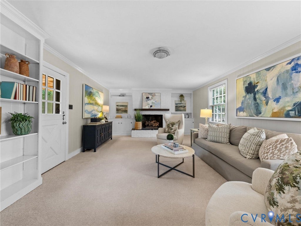1113 E Durwood Crescent, Tuckahoe Area, Henrico, VA 23229 Carpeted living area featuring a brick fireplace, built-in shelving, crown molding, and a paneled door