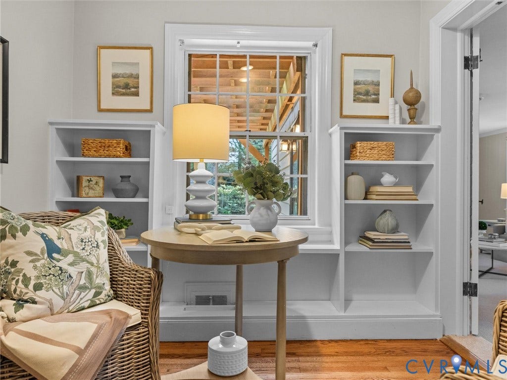 1113 E Durwood Crescent, Tuckahoe Area, Henrico, VA 23229 Wood-finish flooring with built-in shelving flanking a window, featuring white trim and a light-colored wall