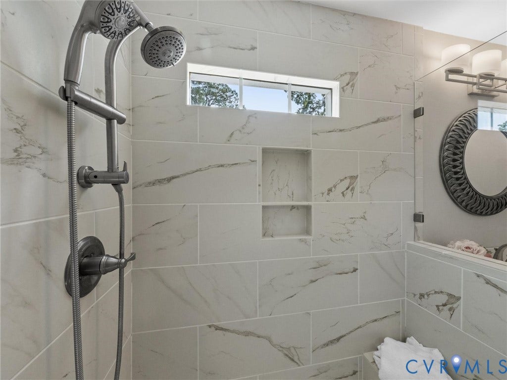 1113 E Durwood Crescent, Tuckahoe Area, Henrico, VA 23229 Shower with large format marble-look tile, built-in recessed shelves, and a fixed showerhead with an adjustable handheld spray