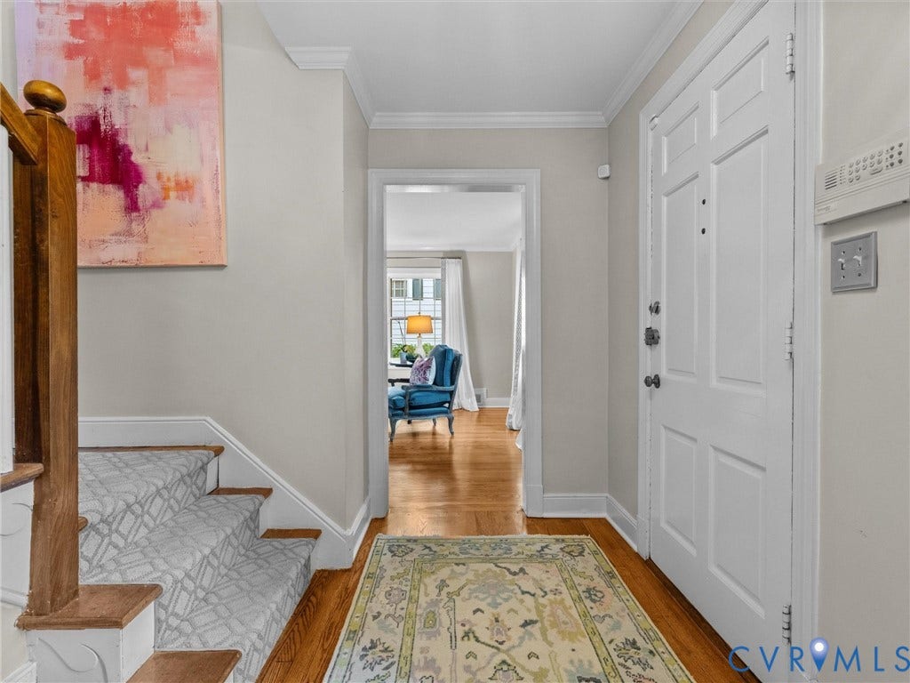 1113 E Durwood Crescent, Tuckahoe Area, Henrico, VA 23229 Hardwood flooring, painted paneled door, crown molding, wood staircase with carpeted treads, and an open doorway
