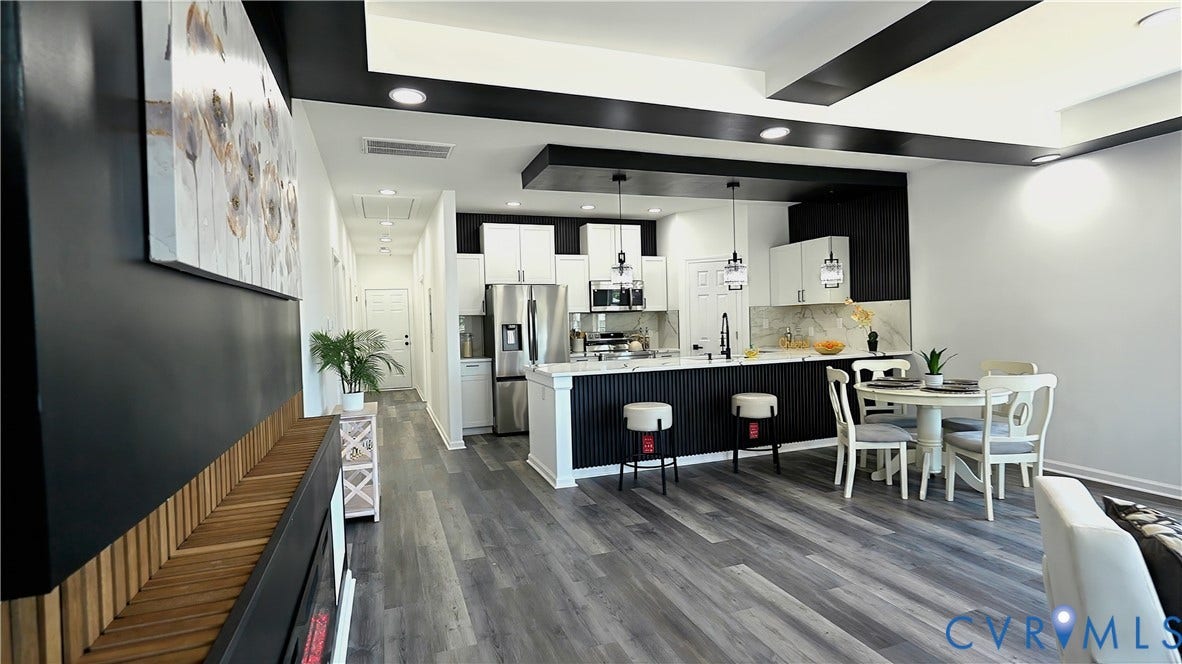 326 Mars Street, Petersburg, VA 23803 Modern kitchen with stainless steel appliances, pendant lighting, white cabinetry, and a fluted island