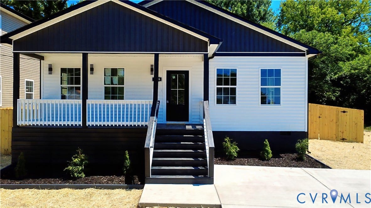 326 Mars Street, Petersburg, VA 23803 Contemporary exterior featuring white horizontal siding and dark vertical siding, covered front porch with white railing, concrete walkway, and dark wood-finish stairs