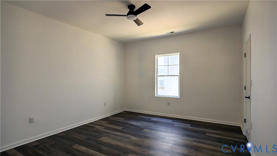 326 Mars Street, Petersburg, VA 23803 Wood-finish plank flooring, ceiling fan with integrated lighting, white interior door with black hardware, and a single-pane window