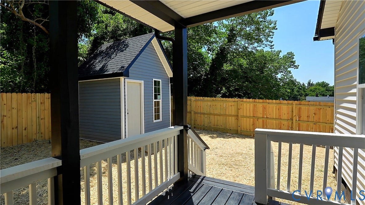 326 Mars Street, Petersburg, VA 23803 Covered porch with dark wood-finish decking and white railings