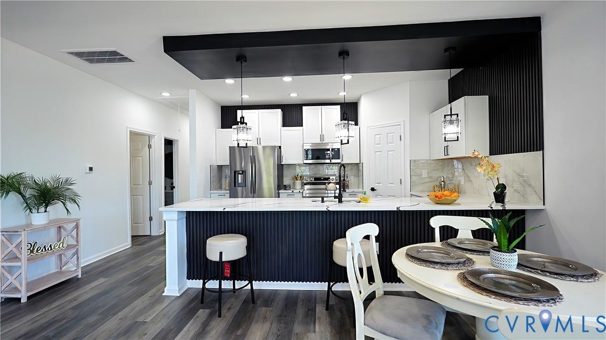 326 Mars Street, Petersburg, VA 23803 Modern kitchen featuring wood-finish flooring, white cabinetry, stainless steel appliances, and an island with a light-colored countertop