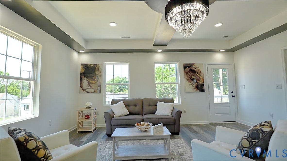 326 Mars Street, Petersburg, VA 23803 Tray ceiling with recessed lighting and a crystal chandelier, multiple windows, and wood-finish flooring