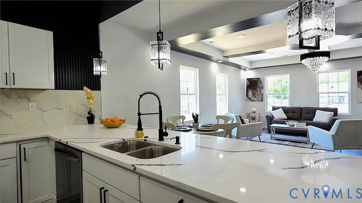 326 Mars Street, Petersburg, VA 23803 Kitchen island featuring an undermount double basin sink with a gooseneck faucet