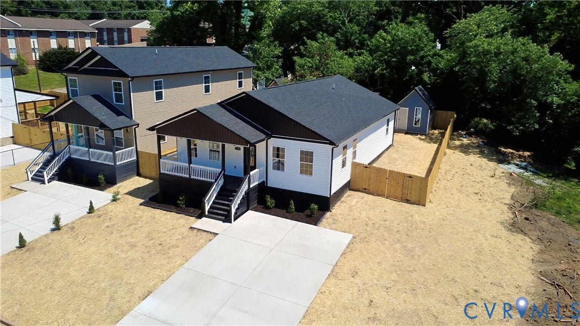 326 Mars Street, Petersburg, VA 23803 Contemporary residence featuring a covered front porch, concrete driveway, dark shingle roof, white siding, and a wooden privacy fence