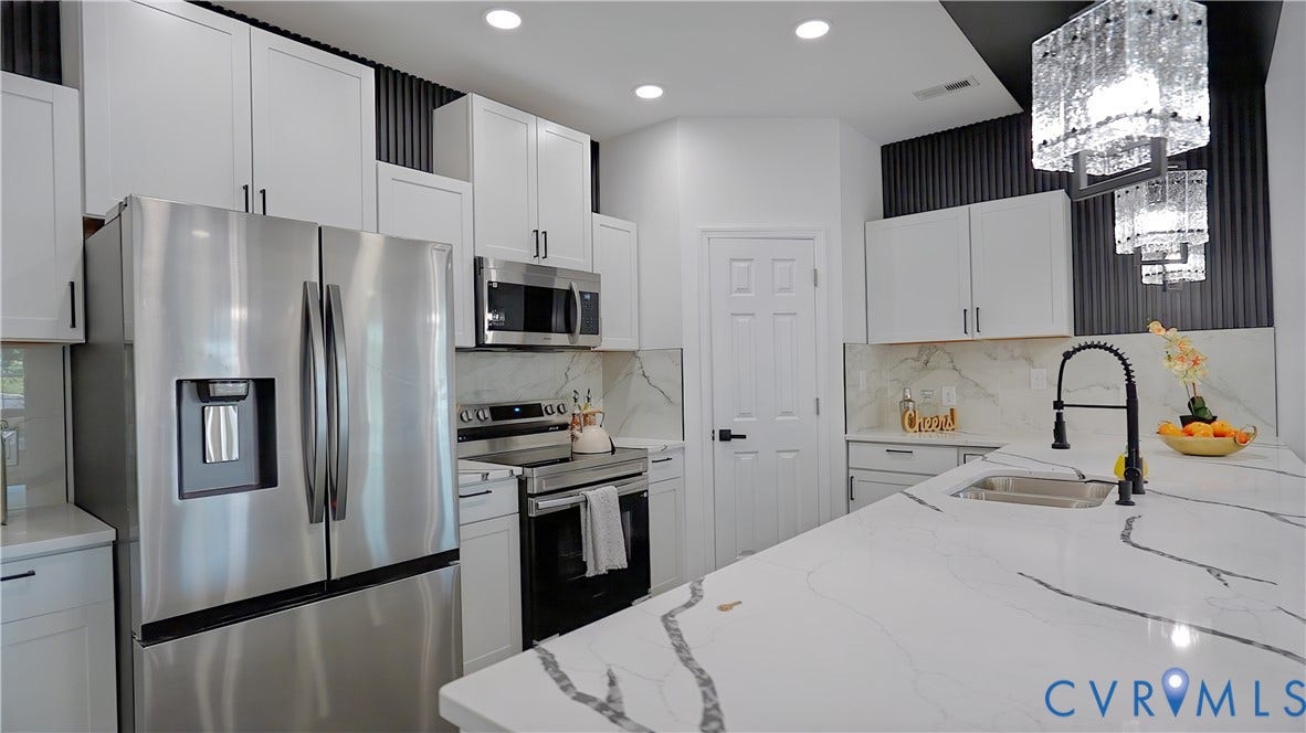 326 Mars Street, Petersburg, VA 23803 Stainless steel appliances, white cabinetry with black hardware, white countertops, built-in sink with matte black faucet, and decorative ceiling lights