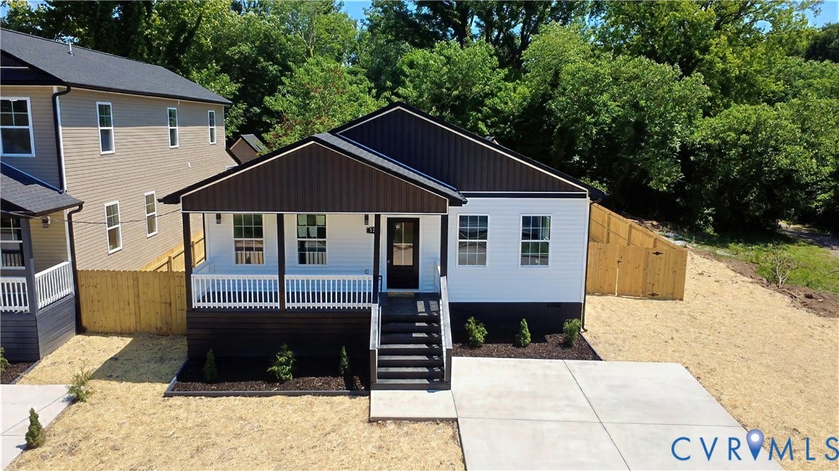 326 Mars Street, Petersburg, VA 23803 Contemporary exterior with a covered front porch, concrete driveway, and a wood privacy fence