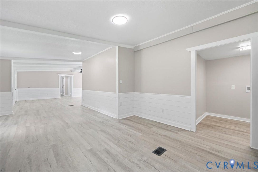 115 Mount Airy Lane, Cumberland, VA 23040 Open-concept interior featuring wood-finish flooring, white shiplap wainscoting, and recessed lighting