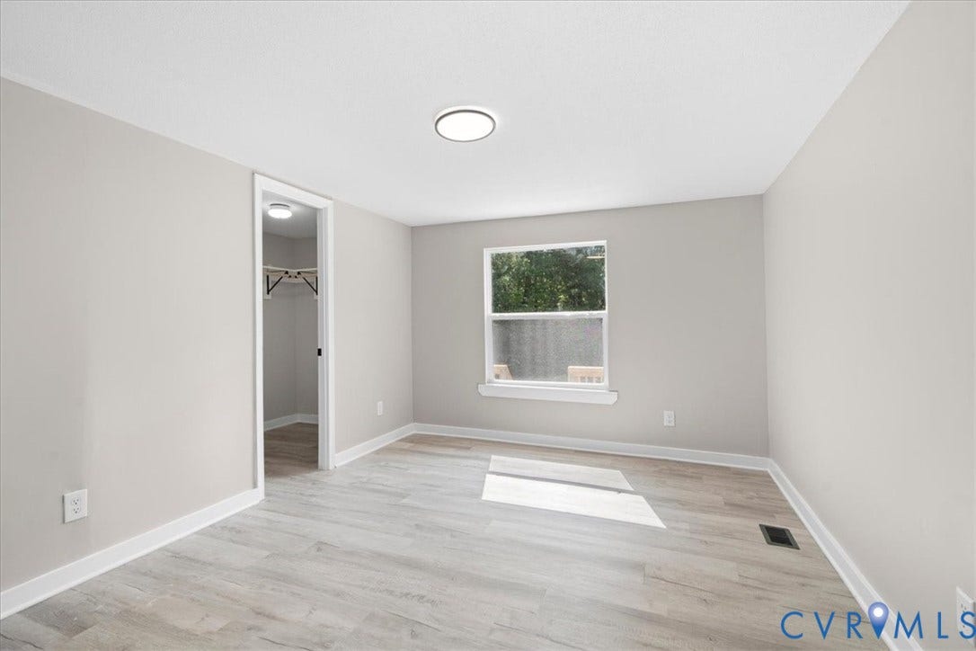 115 Mount Airy Lane, Cumberland, VA 23040 Neutral wall paint, wood-finish flooring, white trim, recessed lighting, and a window with a white frame