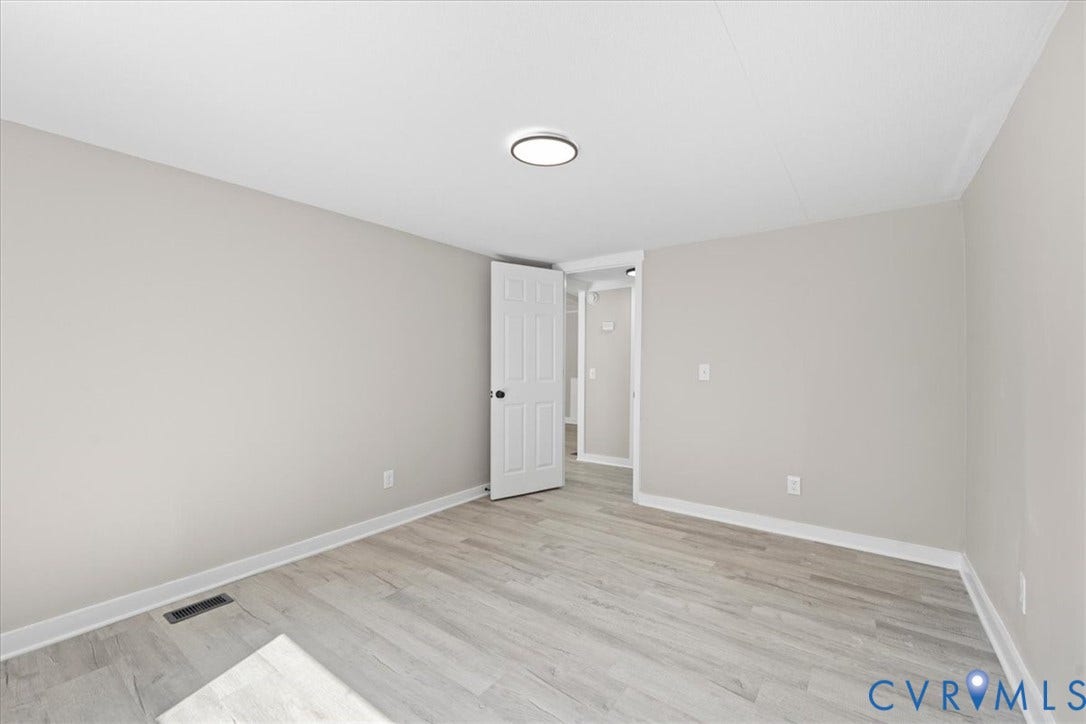 115 Mount Airy Lane, Cumberland, VA 23040 Light wood-finish flooring, white walls, and a ceiling-mounted light fixture
