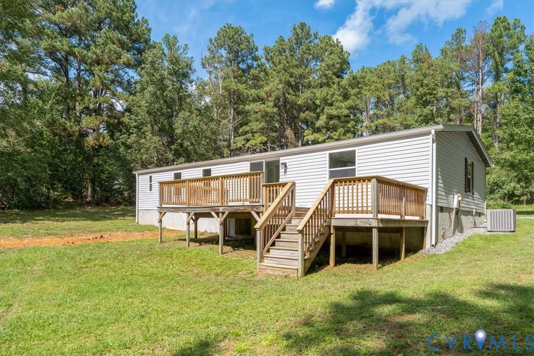 115 Mount Airy Lane, Cumberland, VA 23040 Exterior featuring horizontal vinyl siding, two wooden decks with railings, and established perimeter trees
