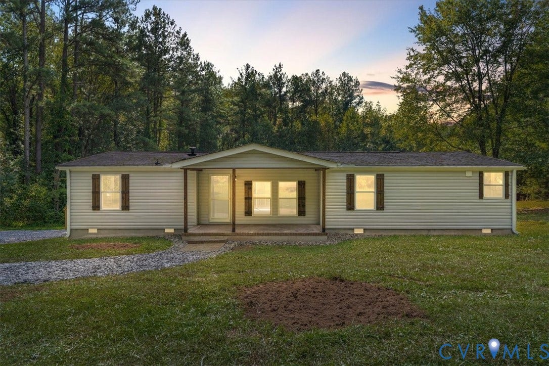 115 Mount Airy Lane, Cumberland, VA 23040 Single-story residence featuring light-colored siding, a covered front porch, and dark louvered shutters