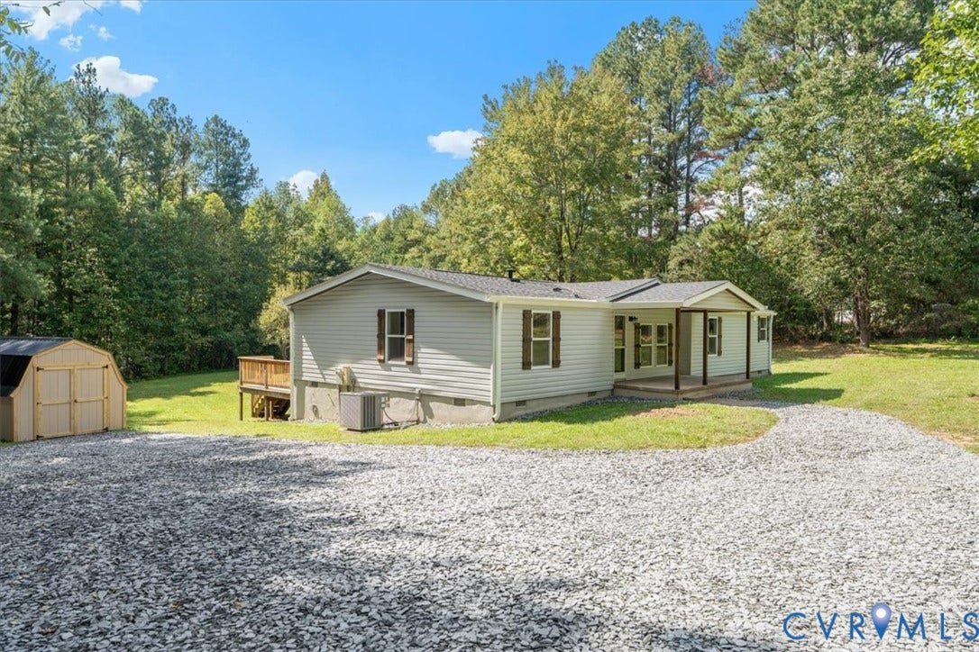 115 Mount Airy Lane, Cumberland, VA 23040 Light-colored siding exterior with dark shutters, covered front porch, and a gravel driveway