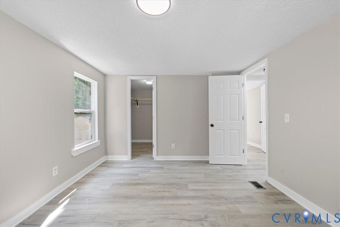 115 Mount Airy Lane, Cumberland, VA 23040 Light wood-finish flooring, neutral wall paint, white trim, recessed lighting, and a single window