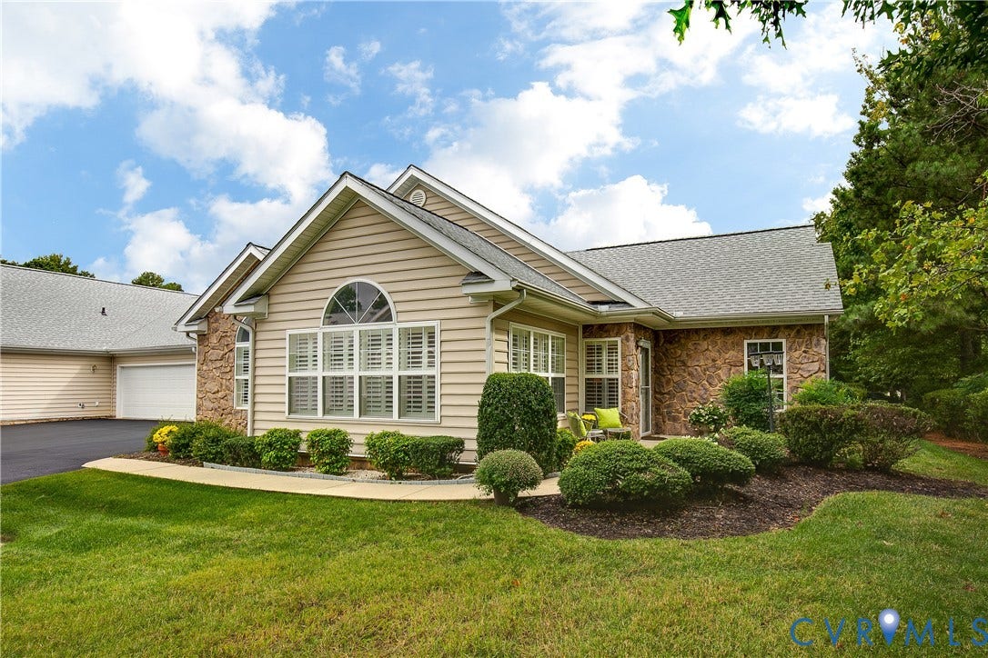 Stone and siding exterior with a pitched roof