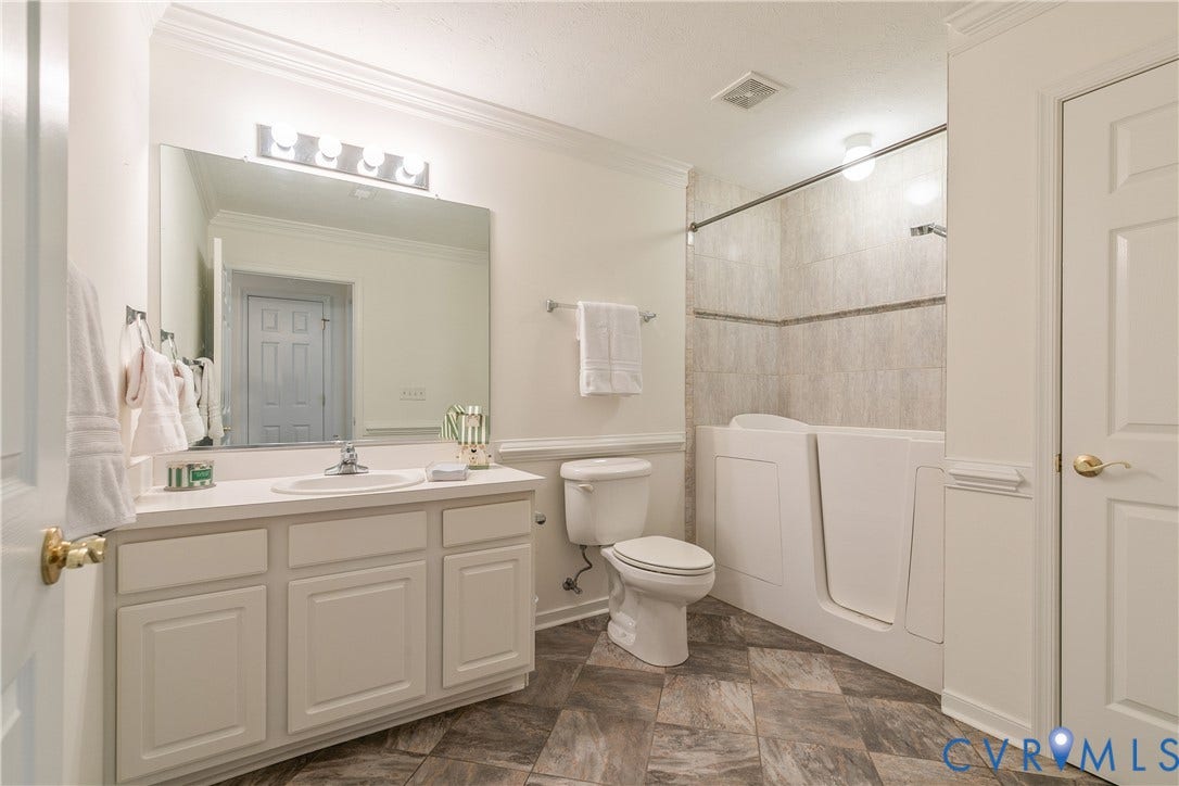 White vanity with integrated sink, rectangular mirror