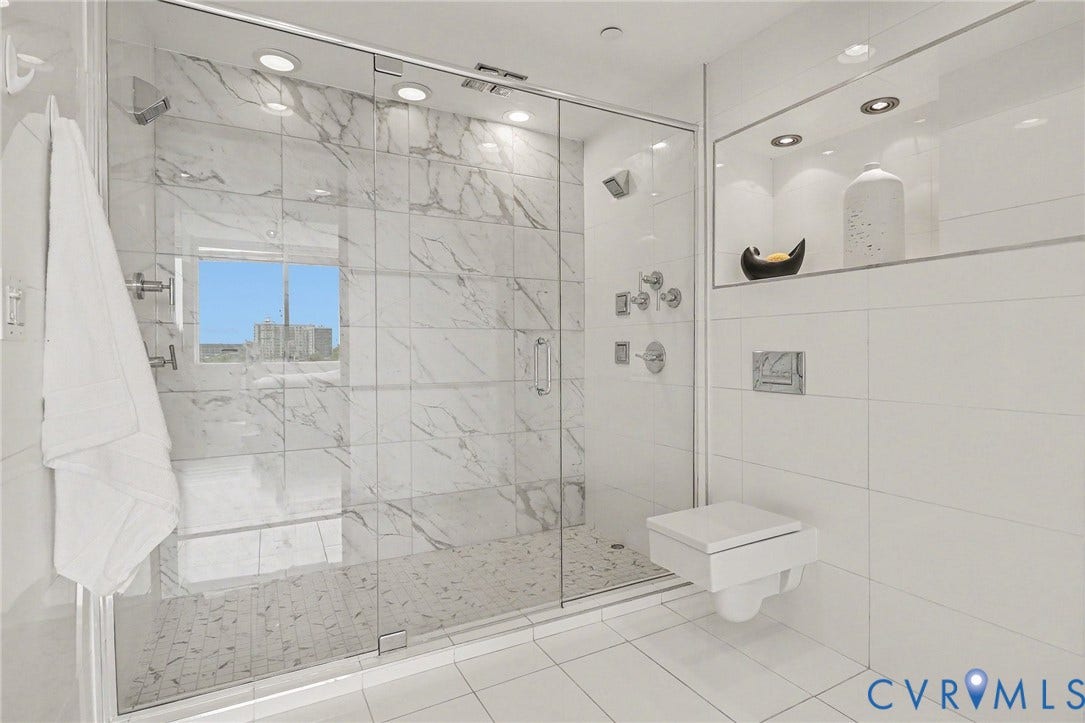 1101 Haxall Point, #U512 U510, Richmond, VA 23219 Glass-enclosed shower with large format marble-look tile, rainfall showerhead, and multiple body sprays