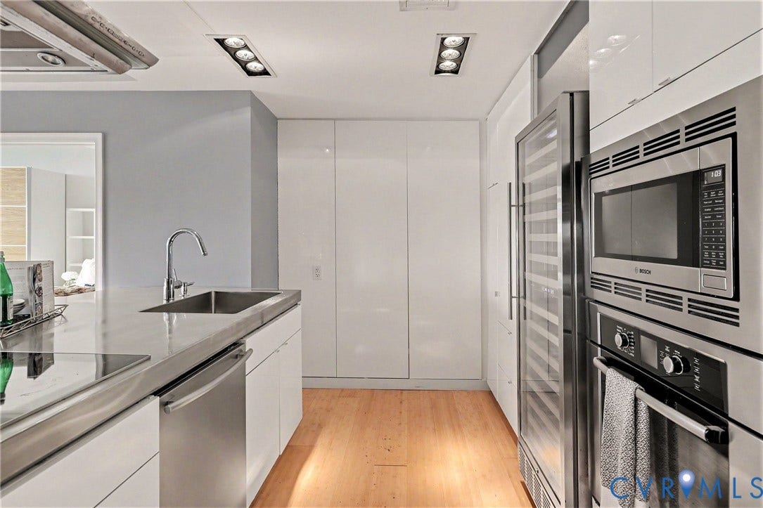 1101 Haxall Point, #U512 U510, Richmond, VA 23219 Modern kitchen featuring a stainless steel undermount sink, integrated dishwasher, built-in microwave, wall oven, and wood-finish flooring