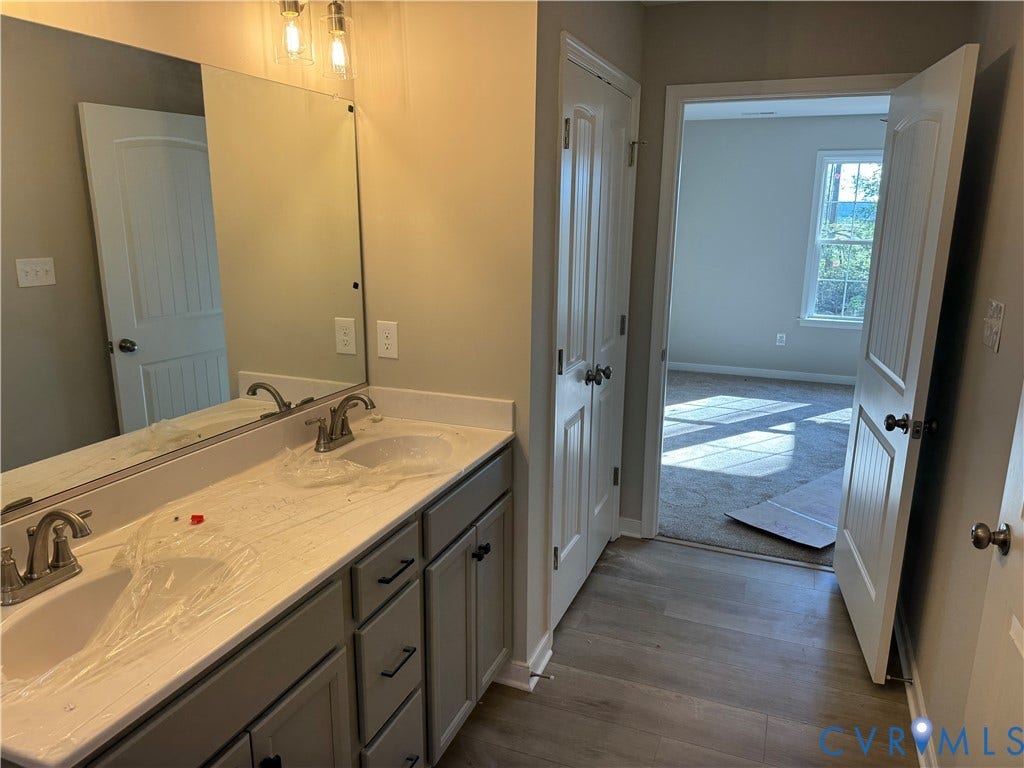 7735 Jefferson Highway, Cedar Hill Park, Mineral, VA 23117 Dual vanity with undermount sinks, single-handle faucets, and a large wall-mounted mirror